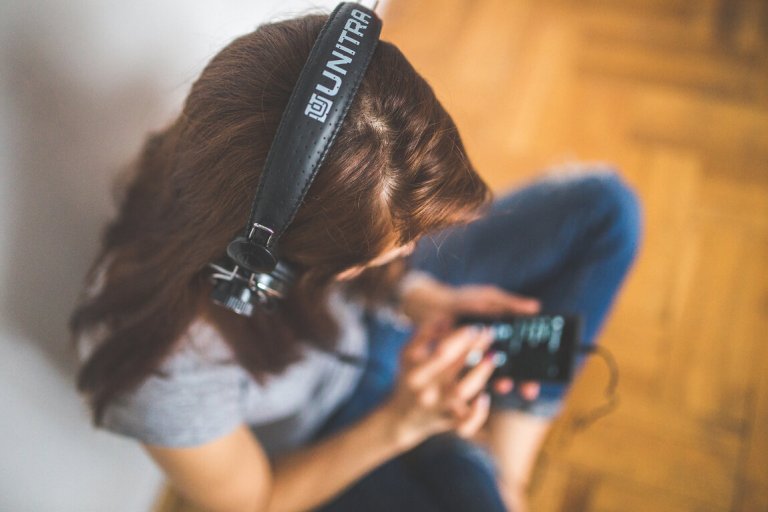 Woman listening to photography podcasts on headphones